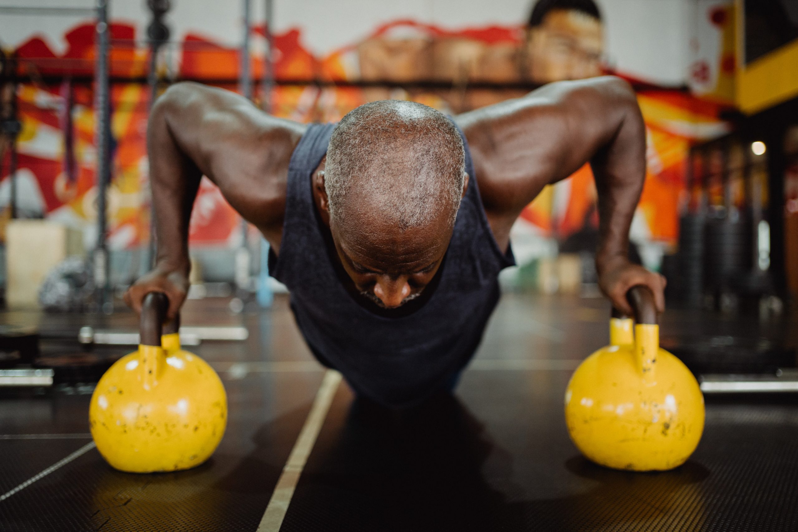 Man doing pushups on kettlebells